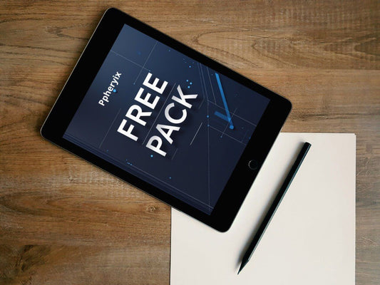 Tablet displaying 'Free Pack' on a wooden surface with a pen and paper.
