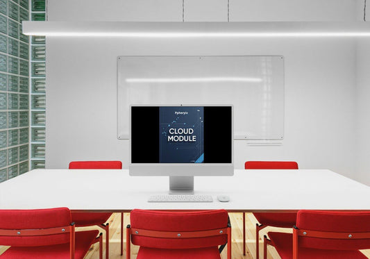 Modern office setting with a computer monitor displaying 'Cloud Module' on a white table with red chairs.