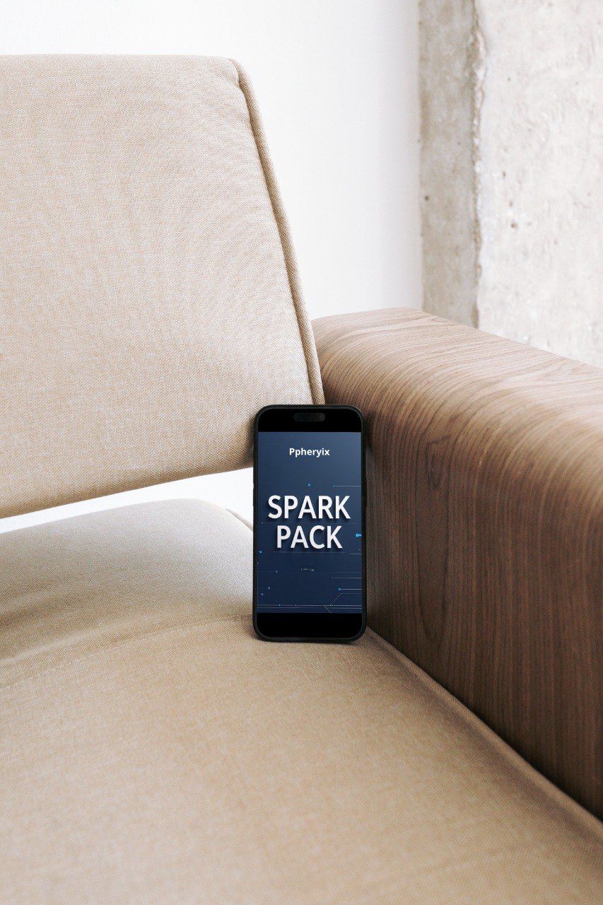 Phone with 'Spark Pack' app displayed on a beige sofa